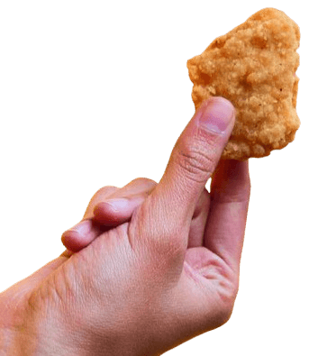 Hand holding a piece of fried fish or chicken nugget